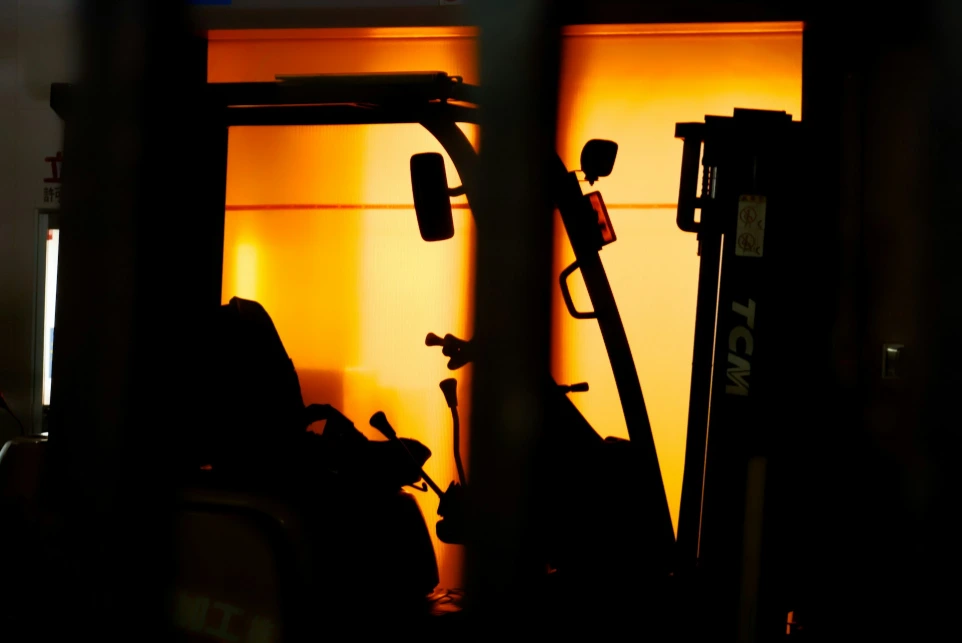 A forklift is parked in front of a building